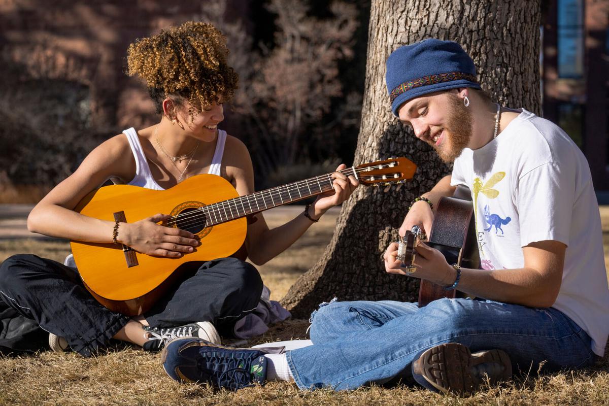 Left, Vitaly Capellan ’26 and Luca Zoeller ’26 play guitar and sing during a relatively warm winter afternoon in Tava Quad on 2/21/23. Photo by Lonnie Timmons III / Colorado College